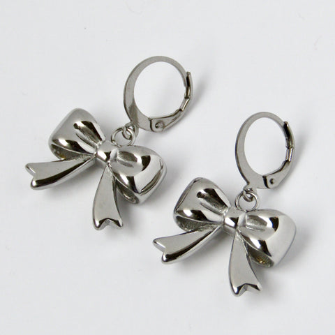 Silver bow-shaped earrings on a light gray background