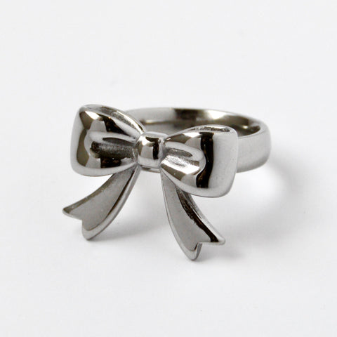 Silver bow-shaped ring on a white background